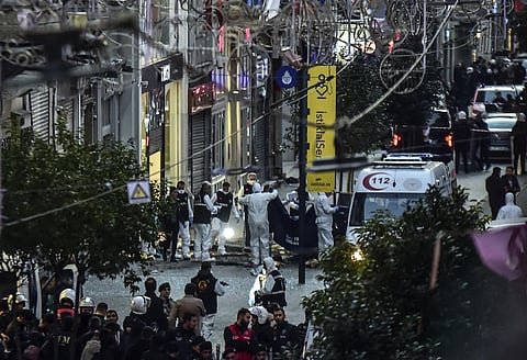 Forensic experts collect a dead body after an explosion on Istanbul's popular pedestrian Istiklal Avenue on November 13, 2022. (Photo | AP)