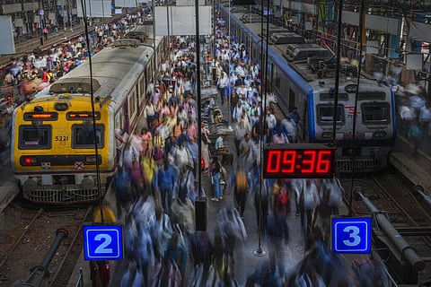 Indian commuters get off trains at the Church Gate railway station in Mumbai, Nov. 14, 2022. (Photo | AP)
