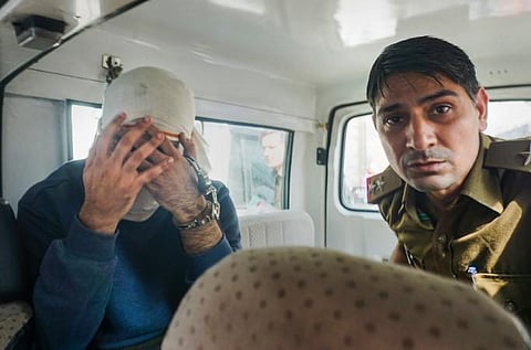 Aaftab Amin Poonawala, accused to have murdered his live-in partner Shraddha Walkar, being brought to the Mehrauli forest area, in New Delhi. (Photo | PTI)