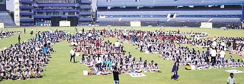 Students from 22 schools making paper boats at Barabati Stadium in Cuttack; (below) Cuttack mayor Subhas Singh and others receiving the record document