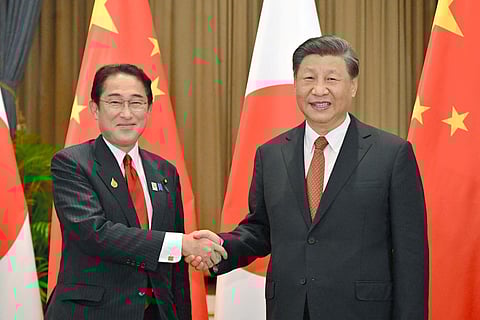 Japan's Prime Minister Fumio Kishida, (L), shakes hands with China's President Xi Jinping during their meeting in Bangkok, Nov. 17, 2022. (Photo | AP)