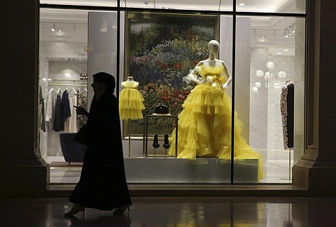 A woman passes by fashion outfit at the Al Hazm luxury mall, in Doha, Qatar, Wednesday, April 24, 2019. (Photo | AP)