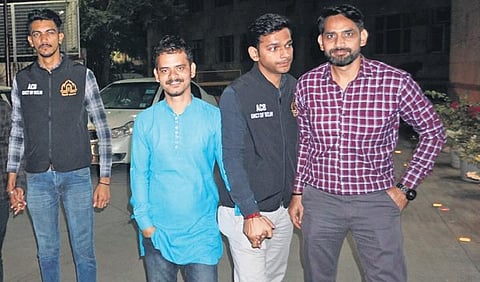 ACB sleuths along with two of the arrested associates of the AAP MLA (Photo | PTI)