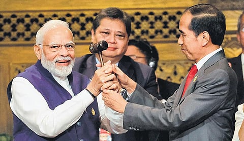 Prime Minister Narendra Modi and Indonesia’s President Joko Widodo take part in the handover ceremony at the G20 Summit in Bali on Wednesday. (Photo | AP)