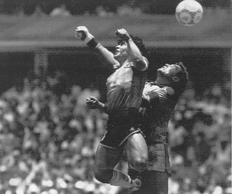 Diego Maradona, left, beats England goalkeeper Peter Shilton to a high ball and scores his first of two goals in a World Cup quarterfinal soccer match, in Mexico City on June 22, 1986. (Photo | AP)