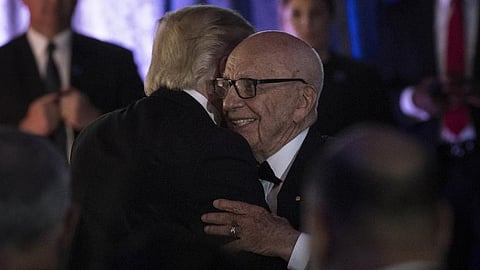 US President Donald Trump embraces Australian-American media proprietor Rupert Murdoch.