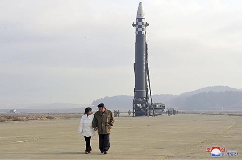 North Korean leader Kim Jong Un, right, and his daughter inspect the site of a missile launch (Photo | AP)