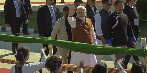 Prime Minister Narendra Modi waves at supporters as he arrives for the inauguration of Donyi Polo Airport and other development projects, in Itanagar. (Photo | PTI)