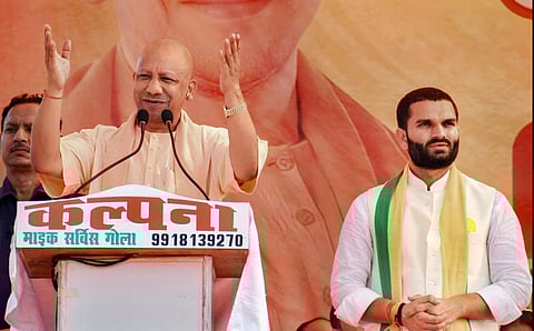 Uttar Pradesh Chief Minister Yogi Adityanath addresses a public meeting in Lakhimpuri Kheri. BJP's Golabypoll candidate Aman Giri is seen. (Photo | PTI)