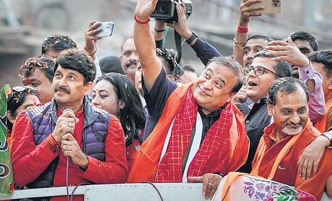 Assam Chief Minister Himanta Biswa Sarma, BJP leader Manoj Tiwari and others during a roadshow ahead of MCD elections on Sunday. (Photo | PTI)