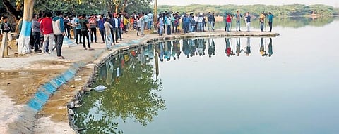 Locals at a pond near Chhatarpur, where Aftab Ameen Poonawala is suspected to have dumped his live-in partner Shraddha Walkar’s head, on Sunday.