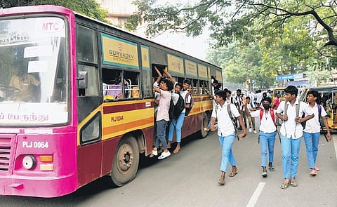 It’s a common sight to see schoolchildren travelling on footboards and hanging out of buses. A scene from Vepery on Monday | R Satish Babu