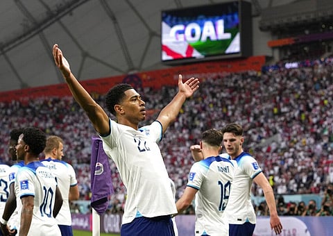 England's Jude Bellingham celebrates after scoring his side's opening goal during the World Cup group B soccer match between England and Iran at the Khalifa International Stadium. (Photo | AP)