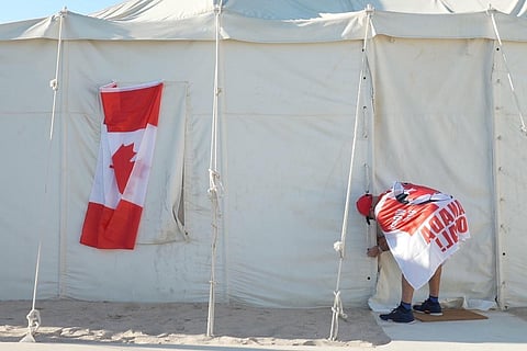 Canadian Modar Safar of Gilbert, Ontario ties closed his tent at a site in Al Khor, Qatar, Wednesday, Nov. 23, 2022. (Photo | AP)