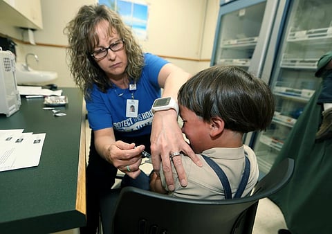 In this backdated image, a registered nurse and immunization outreach coordinator with the Knox County Health Department, administers a vaccination to a kid. (File Photo | AP)