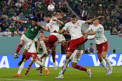 Poland's Grzegorz Krychowiak (10) and Mexico's Edson Alvarez go for a header during a World Cup group C soccer match at the Stadium 974 in Doha, Qatar. (Photo | AP)