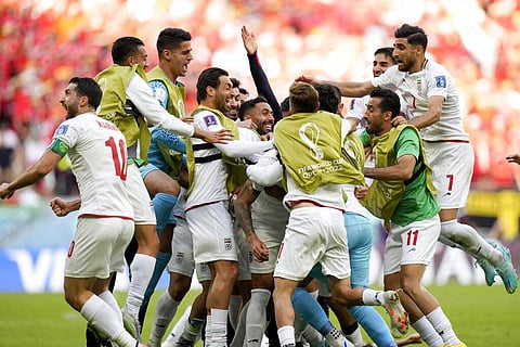Iran's players celebrate after the opening goal during the World Cup group B match against Wales at the Ahmad Bin Ali Stadium in Al Rayyan, Nov. 25, 2022. (Photo | AP)