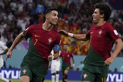 Portugal's Cristiano Ronaldo, left, celebrates with teammate Joao Felix after scoring from the penalty spot his side's opening goal against Ghana, Nov. 24, 2022 (Photo | AP)