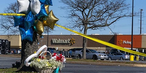 Flowers and balloons have been placed near the scene of mass shooting at Walmart. (Photo |AP)