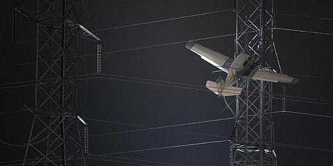 A small plane rests on live power lines after crashing, Sunday, Nov. 27, 2022.(Photo | AP)