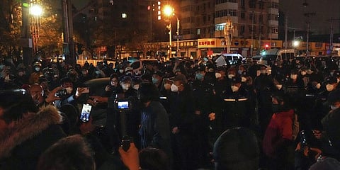 Protesters clash with policemen during a protest in Beijing, Sunday, Nov. 27, 2022.(Photo | AP)