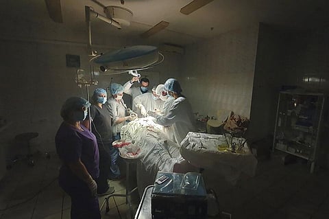 The pic shows the moment when lights at a hospital went out as Ukrainian doctor Oleh Duda was performing complicated, dangerous surgeryat the hospital in western city of Lviv, Ukraine | AP