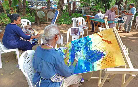 Artists drawing late writer T P Rajeevan at a memorial event held at Ayyankali Hall in Thiruvananthapuram on Sunday. (Photo |B P Deepu, EPS)