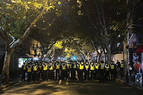 Chinese police officers block off access to a site where protesters had gathered in Shanghai, Nov. 27, 2022. (Photo | AP)