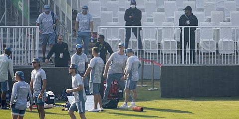 Police officers, right back, stand guard as players of England cricket team arrive for training session at the Rawalpindi cricket stadium in Pakistan.(Photo | AP)
