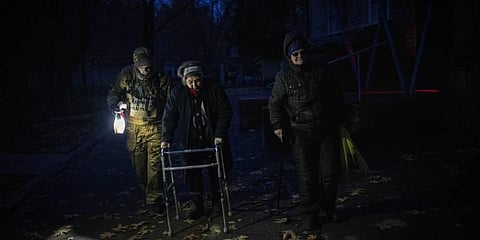 Elderly residents are evacuated from the southern city of Kherson overnight as utility crews continued a scramble to restore power, water and heating following widespread strikes. (Photo | AP)