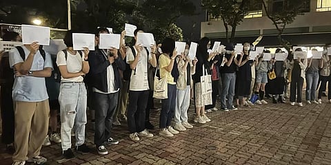Students in Hong Kong chanted “oppose dictatorship” in a protest against China’s anti-virus controls after crowds in mainland cities called for President Xi Jinping to resign. (Photo | AP)