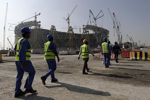Workers walk to the Lusail Stadium, one of the 2022 World Cup stadiums, in Lusail, Qatar, Friday, Dec. 20, 2019. (File Photo | AP)