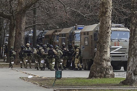 Russian soldiers stand next to their trucks during a rally against Russian occupation in Svobody (Freedom) Square in Kherson, Ukraine, on March 7, 2022. (File Photo | AP)
