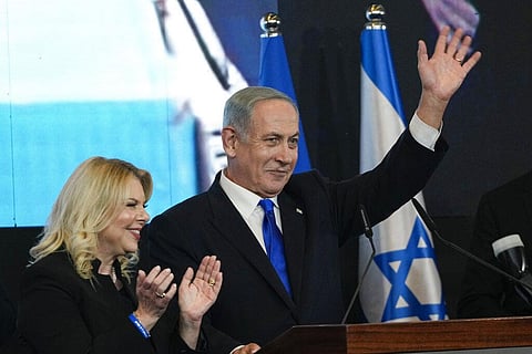 Benjamin Netanyahu, (L), accompanied by his wife Sara waves to his supporters after first exit poll results at his party's headquarters in Jerusalem, Nov. 2, 2022. (Photo | AP)