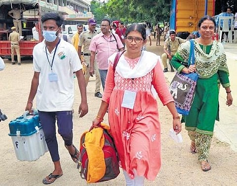 Polling staff collect election material from the distribution centre at Don Bosco Junior College in Chandur mandal on Wednesday