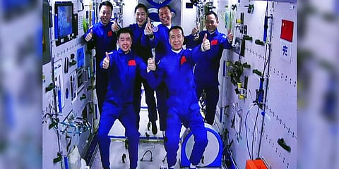 The Shenzhou-15 and Shenzhou-14 crew taking a group picture with their thumbs up after a historic gathering in space on Nov. 30, 2022 | AP