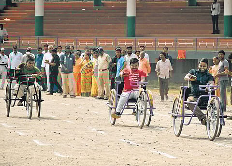Students with different abilities take part in tricycle competition at IGMC Stadium in Vijayawada on Tuesday. (Photo | Prasant Madugulay, EPS)