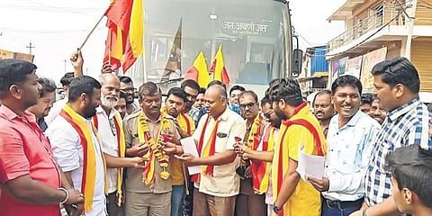 KRV activists felicitate public bus drivers from Maharashtra with garlands and shawls containing prints of the Karnataka emblem in Athani on Tuesday.(Photoshop | Express)