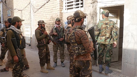 Taliban fighters stand outside as they conduct a 'house to house' inspection in Kabul, September 11, 2022. (File Photo | AFP)