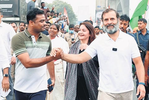 Congress MP Rahul Gandhi greets a supporter as actor Pooja Bhatt looks on during his Bharat Jodo Yatra in Hyderabad on Wednesday