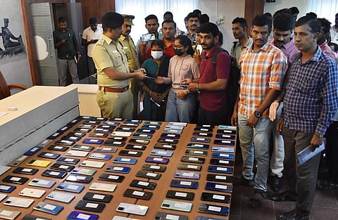 Superintendent of police V Badrinarayanan hand over the recovered mobile phones to the owners on Saturday at the SP’s office