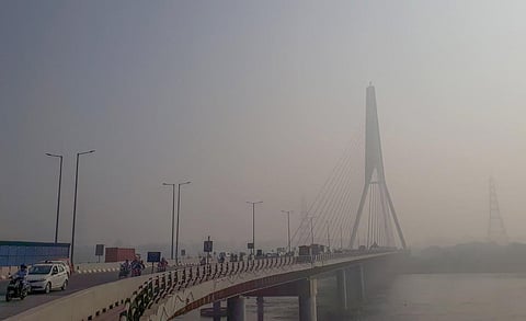 Vehicles ply on the Signature Bridge amid low visibility due to smog, in New Delhi, on November 7, 2022. (Photo | PTI)