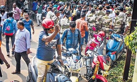 A member of Bajrang Dal gestures at rationalists who were distributing chicken biryani on lunar eclipse at Lohia Academy in Bhubaneswar on Tuesday | Express
