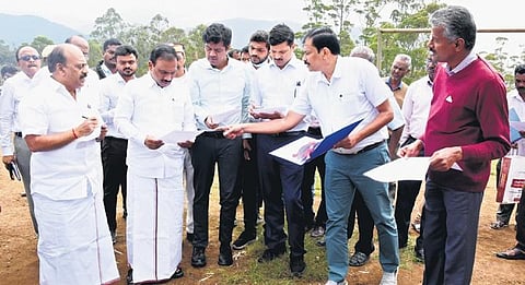 Minister TM Anbarasan, Nilgiris MP Raja, and district Collector SP Amrith inspect Naduvattam panchayat, where houses are to be built for retired Tantea staff | Express
