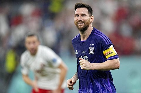 Argentina's Lionel Messi smiles during the World Cup group C soccer match between Poland and Argentina at the Stadium 974 in Doha, Qatar on Nov. 30, 2022 | AP