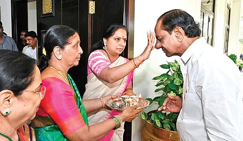 TRS MLC K Kavitha applies tilak on the forehead of her father and Chief Minister K Chandrasekhar Rao before the launch of Bharat Rashtra Samithi in Hyderabad.