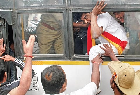 Members of Kannada organisations being detained by the police in front of the Bank of Maharashtra branch at Gandhinagar, in Bengaluru on Friday | Express