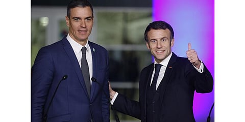Spain's Prime Minister Pedro Sanchez (L) and France's President Emmanuel Macron react after holding a joint press conference. (Photo | AFP)