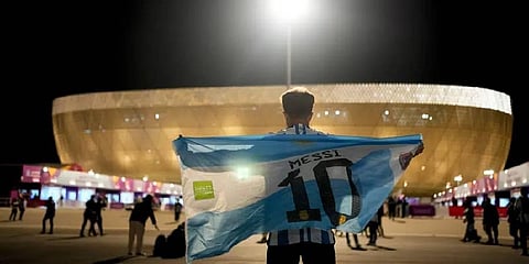 A man holds an Argentinian flag prior to the World Cup quarterfinal soccer match between the Netherlands and Argentina (Photo | AP)