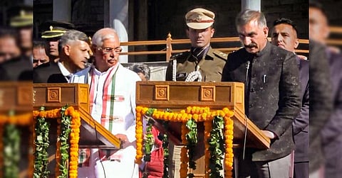 Congress leader Sukhvinder Singh Sukhu, (R), sworn-in as Himachal Pradesh Chief Minister by Governor Rajendra Arlekar at a ceremony, in Shimla, Dec. 11, 2022. (Photo | PTI)